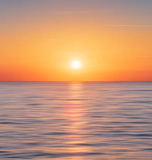 Serene orange sunset over water symbolizing calm, hope and emotional healing in counselling services in Melbourne.