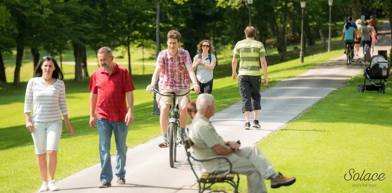 People walking through a Melbourne park representing population-level anxiety statistics.